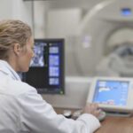 Radiology technician readies CT machine for scanning