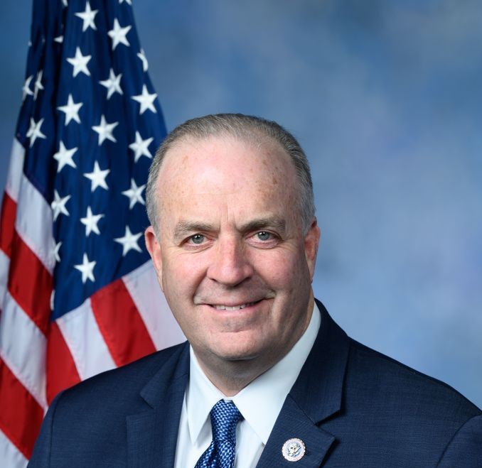 Congressman Dan Kildee poses in front of American Flag. He announced that a preventative scan found early stage cancer, and has a good prognosis.