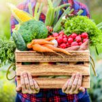 Photograph of crate full of vividly colored vegetables