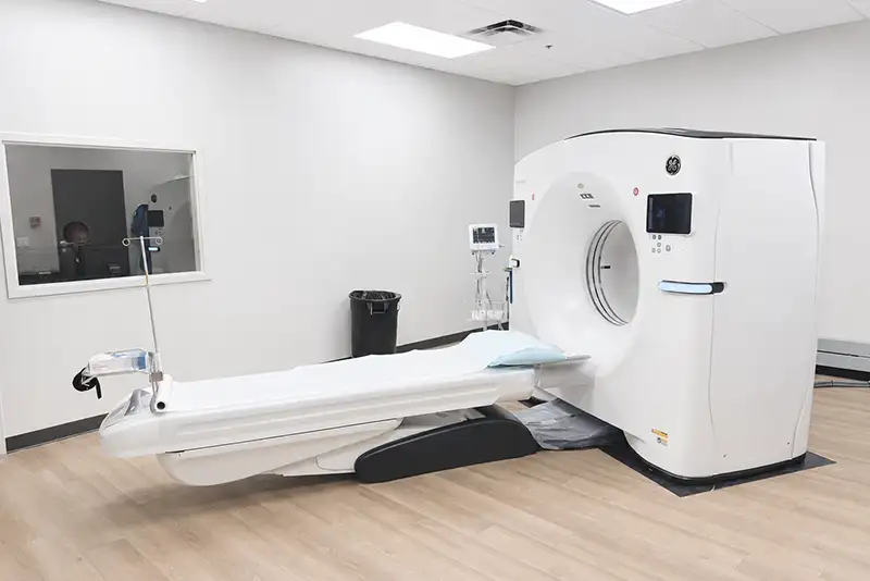 Bright CT scan room at Visionary Wellness & Imaging with a GE scanner and exam table for full body imaging.