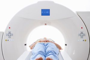 Patient lying on a CT scanner table for preventive full body imaging.